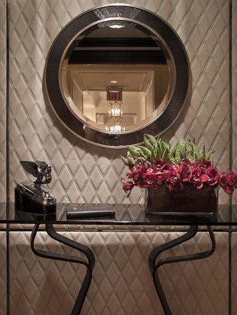 The entryway features a leather wall and leather tile