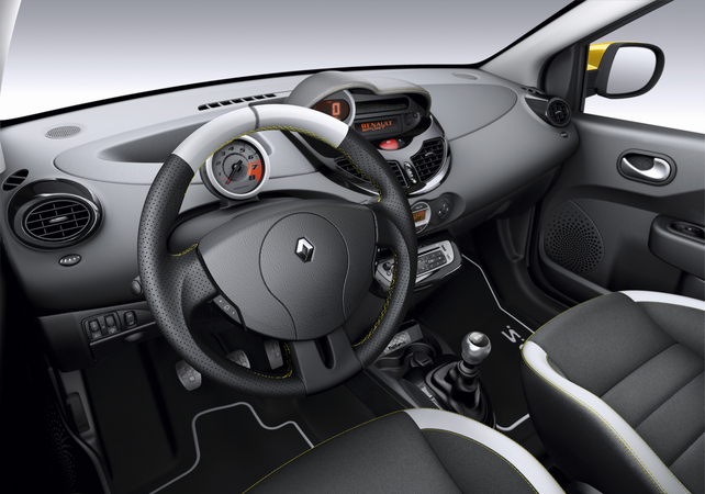 The steering wheel, seats and dashboard have yellow stitching