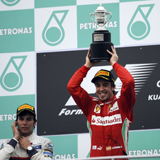 Alonso takes win in wet race in Sepang